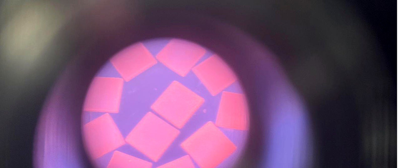 Lab-grown diamond plates fluorescing under ultraviolet light